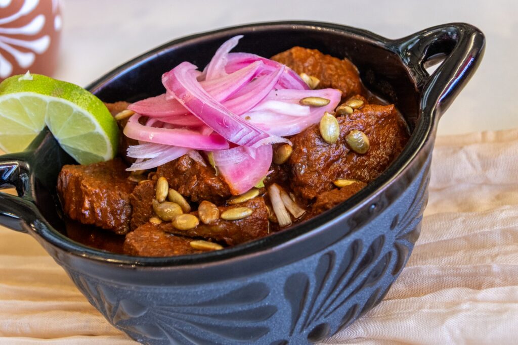 Mexican-style braised beef served with pickled red onions, toasted pepitas, and lime garnish as part of a catered event menu at The Pavilion at Haggin Oaks.