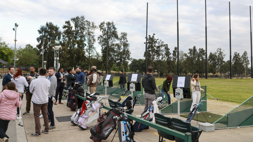 People at a Networking Event at Haggin Oaks's The Hang Out at the Driving Range. At the Hitting Bays
