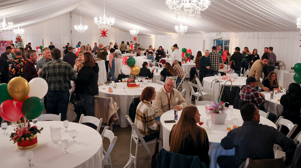 a group of individuals spread out among tables and decorations in the Haggin Oaks Pavilion.