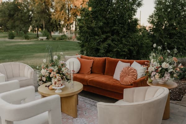 Outdoor wedding lounge setup at Creekside at Haggin Oaks with seating and floral arrangements.