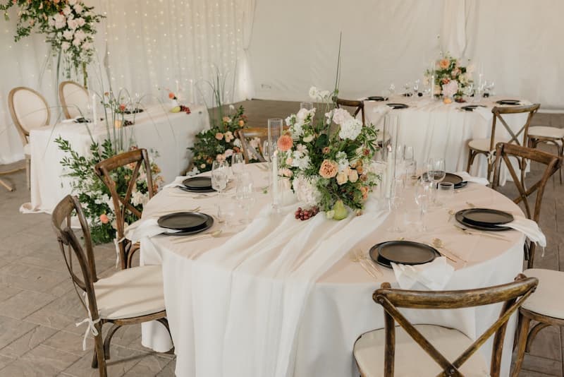 Wedding reception table setup at Creekside at Haggin Oaks with floral centerpieces and elegant place settings.