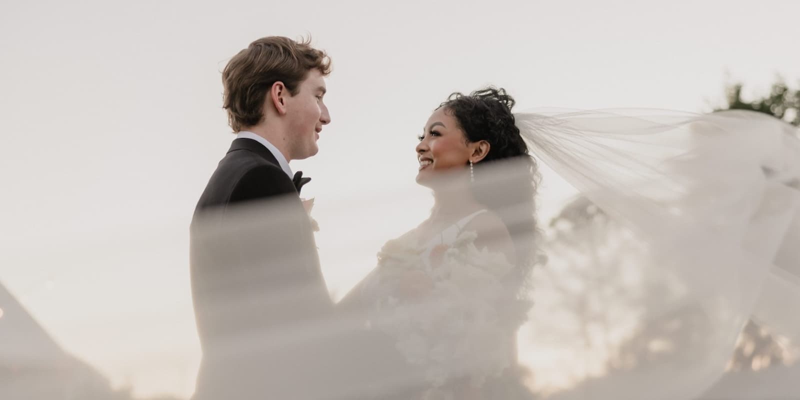 Bride and groom sharing a joyful moment during their wedding at the Pavilion at Haggin Oaks.
